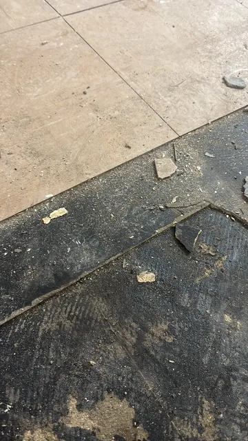 Black bitumen mastic floor removal in a W8 flat